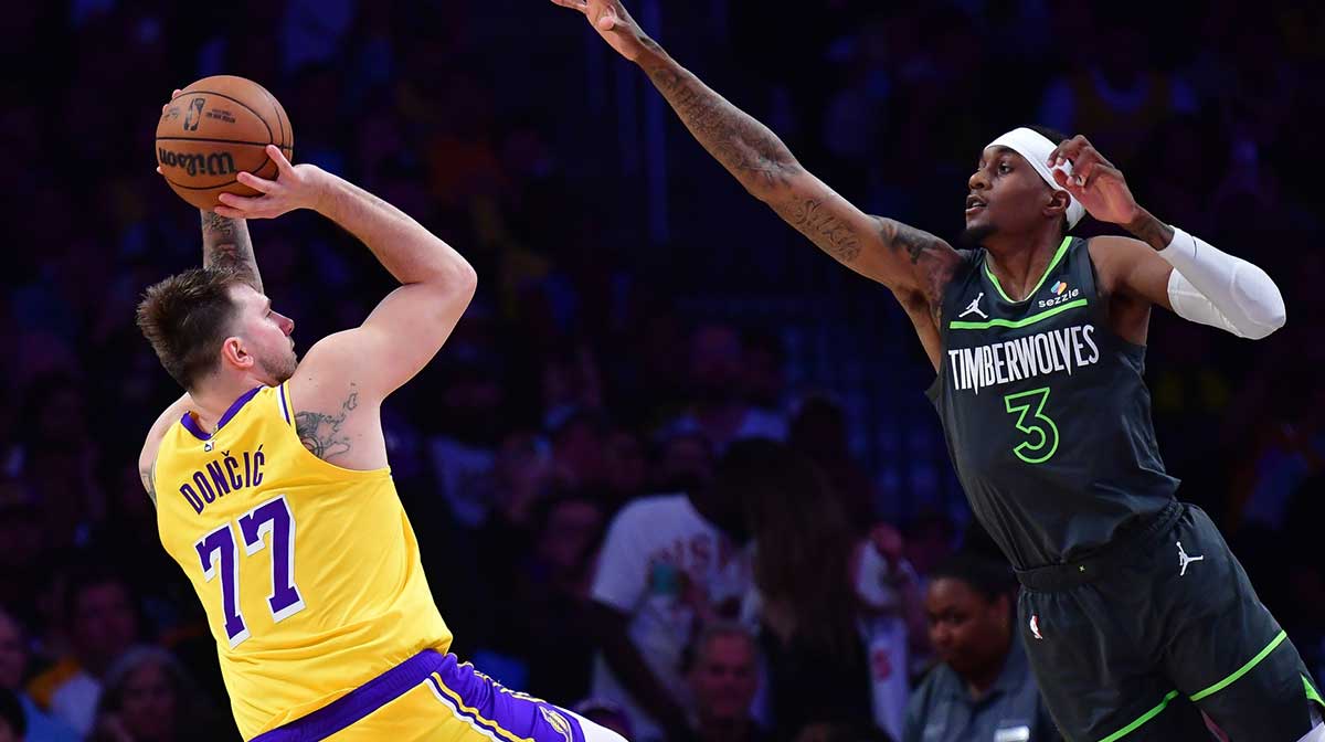 Los Angeles Lakers guard Luka Doncic (77) shoots against Minnesota Timberwolves forward Jaden McDaniels (3) during the second half in game five of first round for the 2025 NBA Playoffs at Crypto.com Arena.