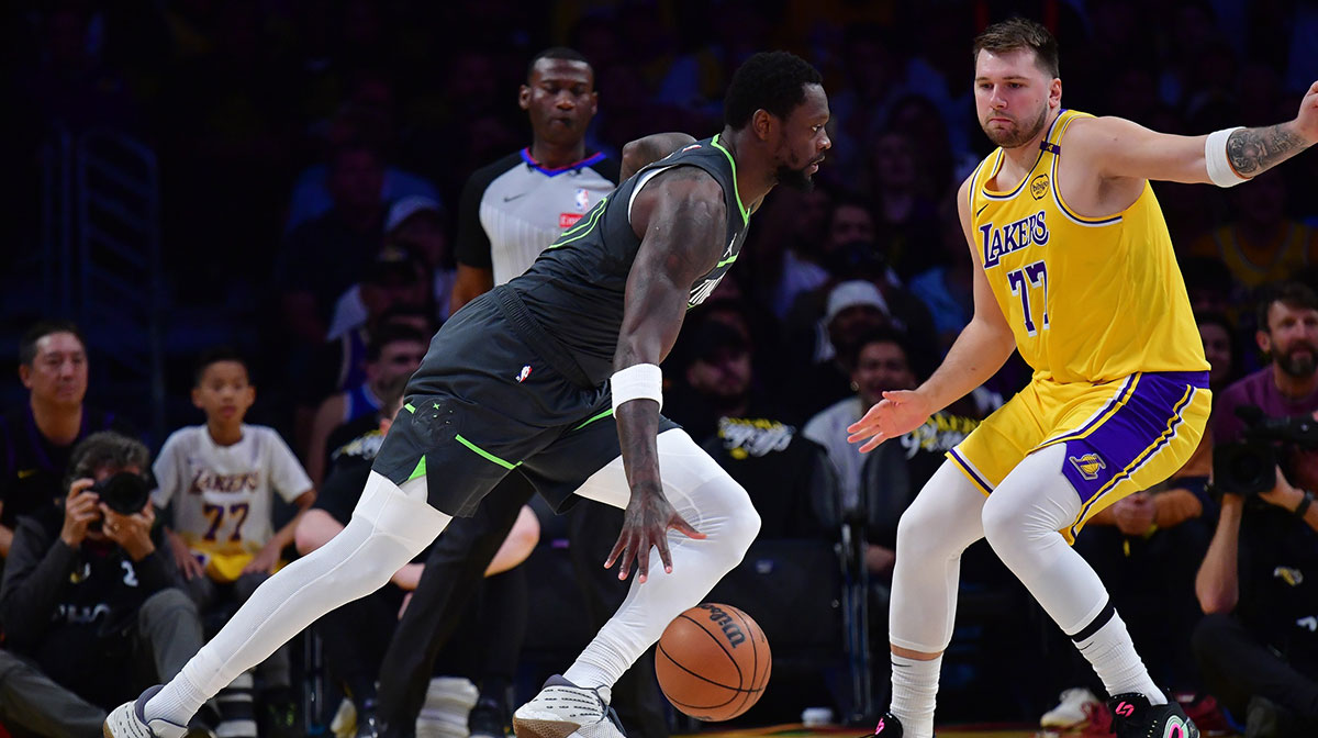 Minnesota Timberwolves guard Anthony Edwards (5) moves to the basket against Los Angeles Lakers guard Luka Doncic (77) during the first half in game five of first round for the 2025 NBA Playoffs at Crypto.com Arena.