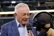 Dallas Cowboys owner Jerry Jones speaks to a reporter before an NFL preseason football game...