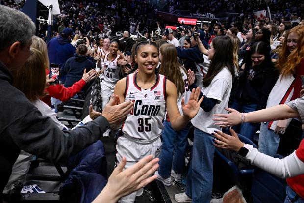 UConn guard Azzi Fudd (35) slaps hands with fans and the student section after an NCAA college basketball game against Marquette, Sunday, March 2, 2025, in Storrs, Conn. (AP Photo/Jessica Hill)