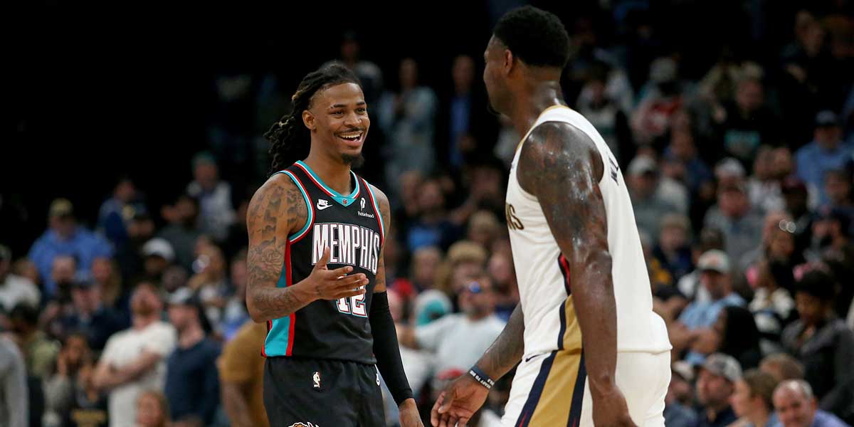 Memphis Grizzlies guard Ja Morant (12) reacts toward New Orleans Pelicans forward Zion Williamson (1) during the fourth quarter at FedExForum.