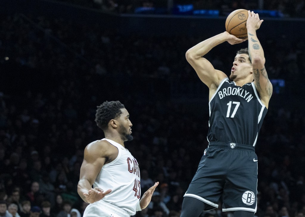 Michael Porter Jr., who scored 31 points, shoots over Donovan Mitchell during the Nets' loss to the Cavaliers in their home opener.