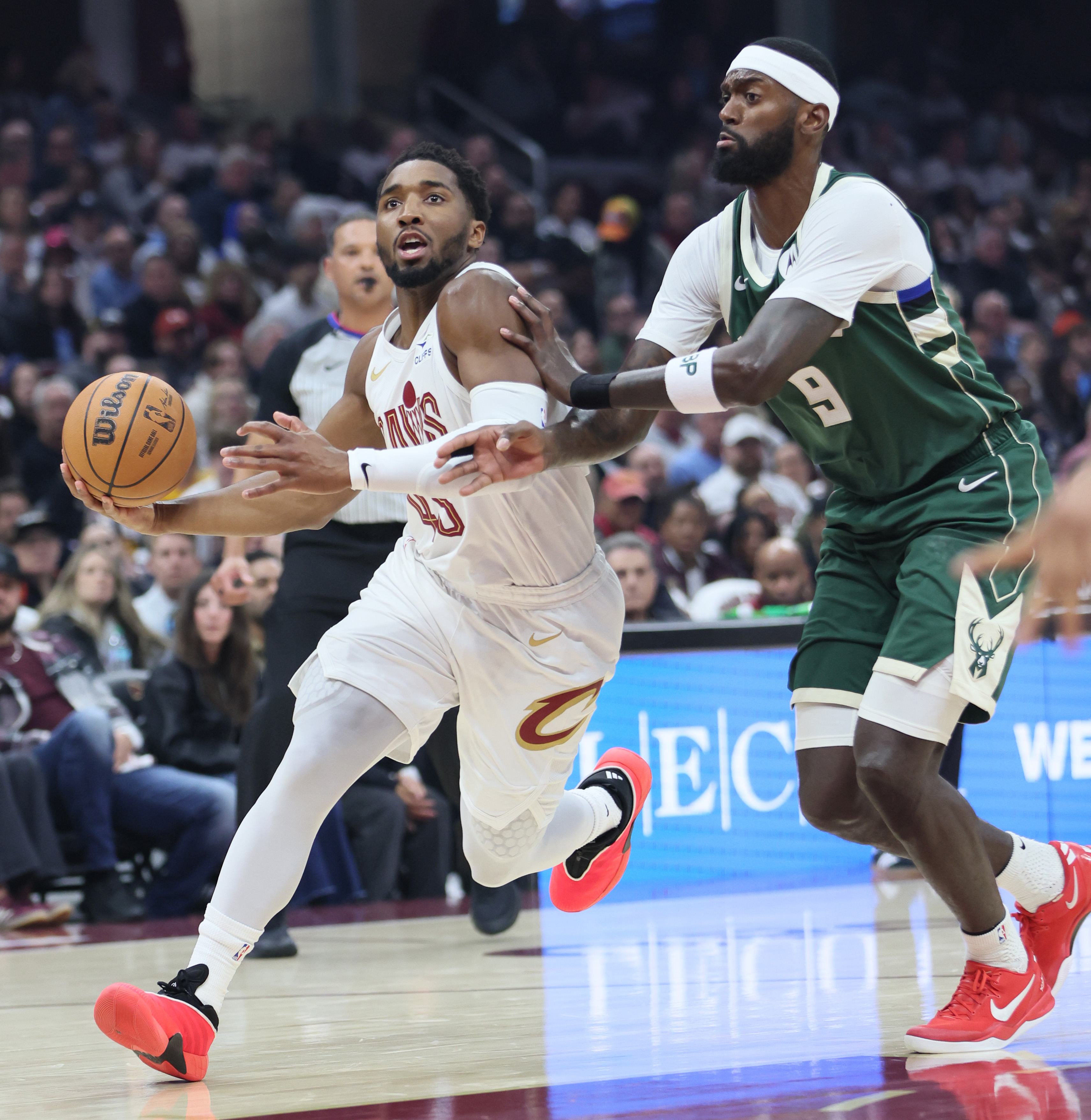 Cleveland Cavaliers guard Donovan Mitchell drives towards the basket guarded by Milwaukee Bucks forward Bobby Portis in the first half at Rocket Arena. 