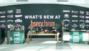 All new beverage and food items are put in display on tablles in front of a backdrop that says "What's new at fiserv.forum"