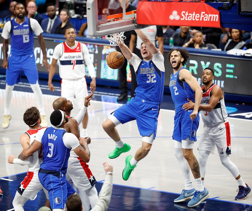Dallas Mavericks forward Cooper Flagg (32) throws down a fourth quarter dunk against the...