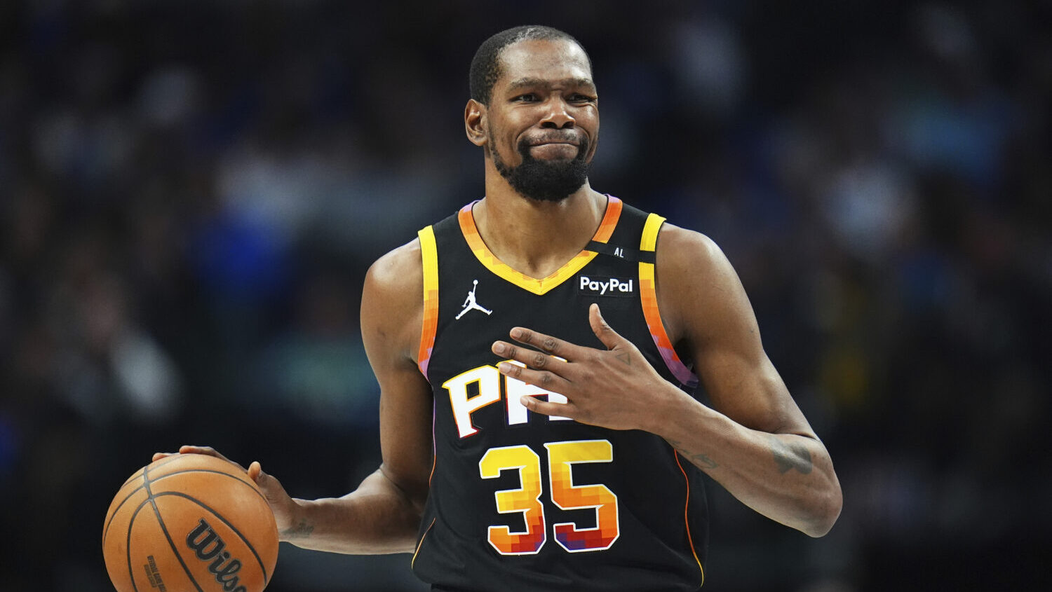 Phoenix Suns forward Kevin Durant gestures during the second half of an NBA basketball game on Marc...