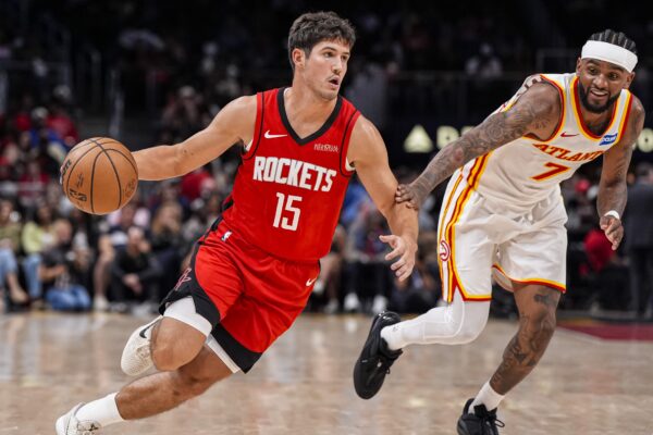 Houston Rockets guard Reed Sheppard (15) dribbles past Atlanta Hawks guard Nickeil Alexander-Walker (7) during the second half at State Farm Arena.