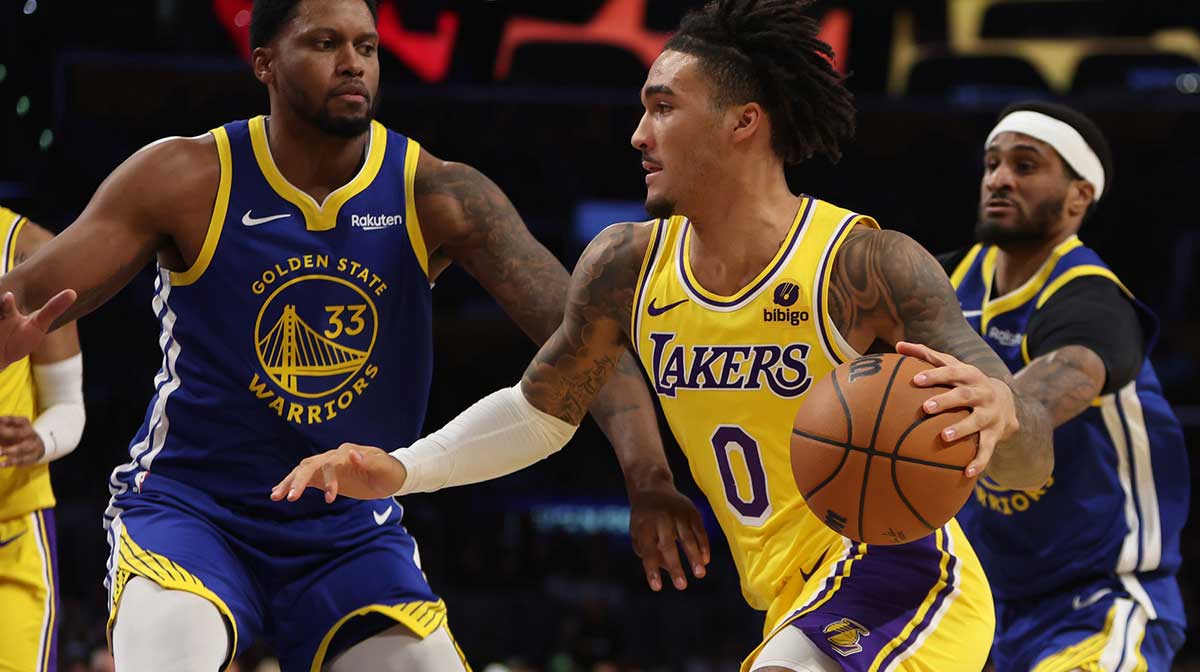 Los Angeles Lakers guard Jalen Hood-Schifino (0) drives to the basket against Golden State Warriors forward Rudy Gay (33) during the third quarter at Crypto.com Arena.