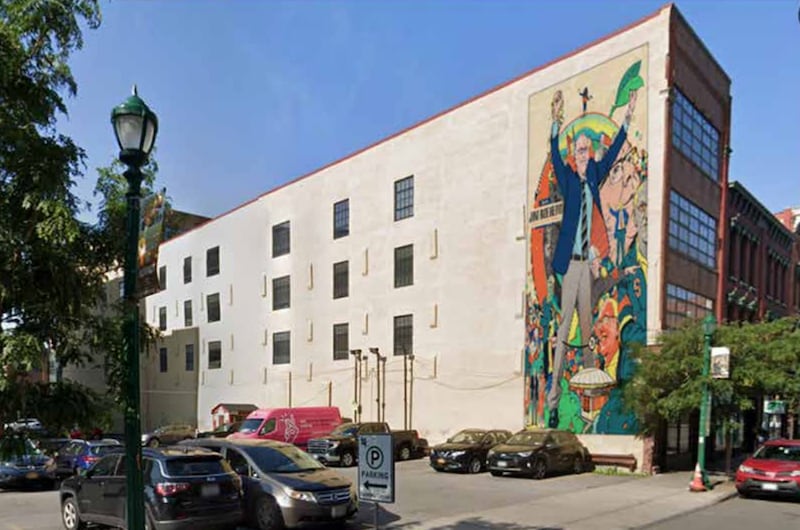 Artist Chris Murray redesigned his Jim Boeheim mural to be painted at 215 W. Fayette St in downtown Syracuse. He received permission from the former coach and is seeking approval from the city public arts commission.