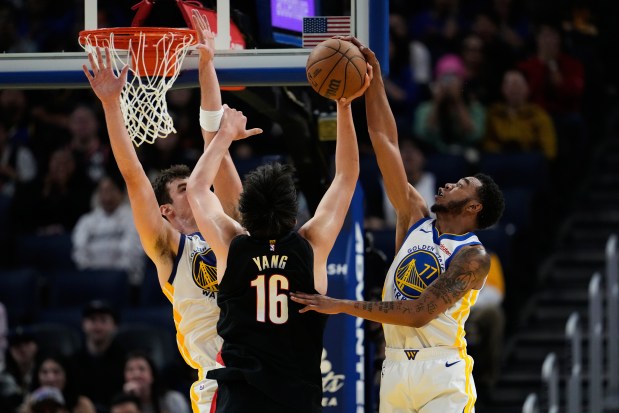 Golden State Warriors guard Taevion Kinsey, right, blocks a shot by Portland Trail Blazers center Yang Hansen during the second half of an NBA preseason game Oct. 8 in San Francisco. (AP Photo/Godofredo A. Vásquez - The Associated Press)