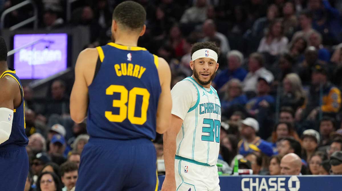 Charlotte Hornets guard Seth Curry (right) talks with Golden State Warriors guard Stephen Curry (left) during the fourth quarter at Chase Center.
