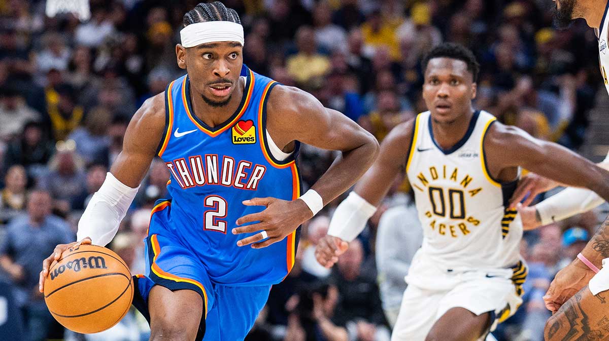 Oklahoma City Thunder guard Shai Gilgeous-Alexander (2) dribbles the ball while Indiana Pacers guard Bennedict Mathurin (00) defends in the second half at Gainbridge Fieldhouse.