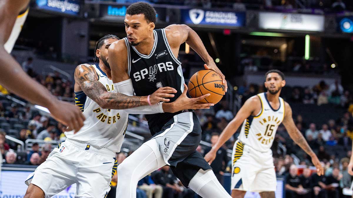 San Antonio Spurs forward/center Victor Wembanyama (1) dribbles the ball while Indiana Pacers forward Obi Toppin (1) defends in the second half at Gainbridge Fieldhouse.