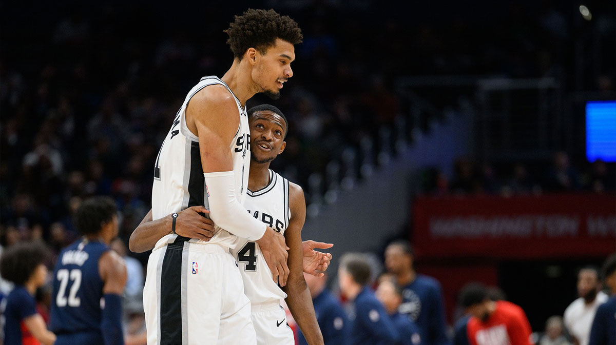 Spurs center Victor Wembanyama (1) and guard De'Aaron Fox (4) react during the second quarter against the Washington Wizards at Capital One Arena