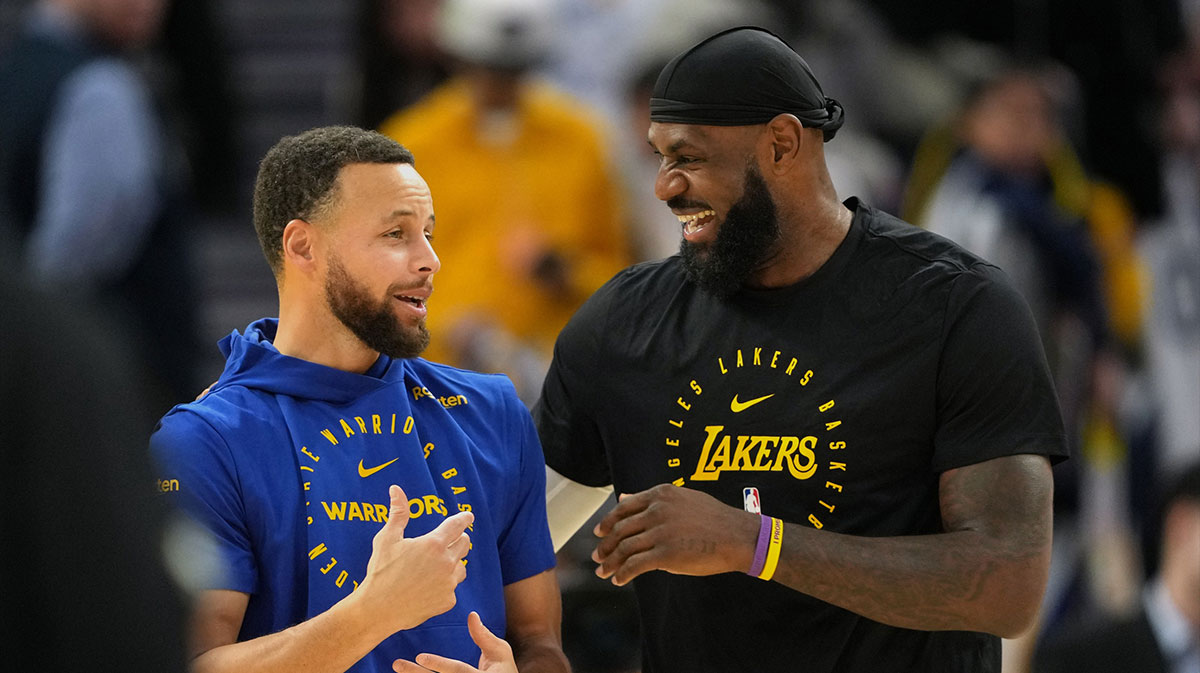 Golden State Warriors guard Stephen Curry (left) and Los Angeles Lakers forward LeBron James (right) talk before the game at Chase Center. 