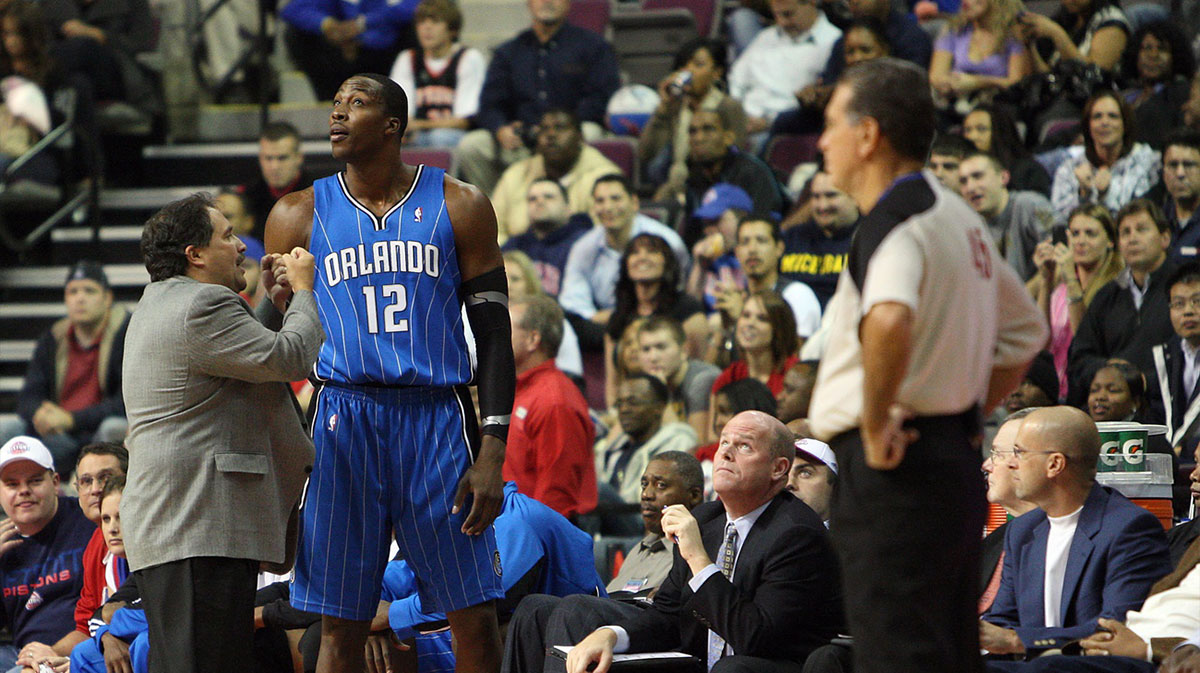 Orlando Magic center Dwight Howard (12) fouls out in the fourth quarter and talks with head coach Stan Van Gundy at The Palace of Auburn Hills. The Pistons defeated the Magic 85-80.
