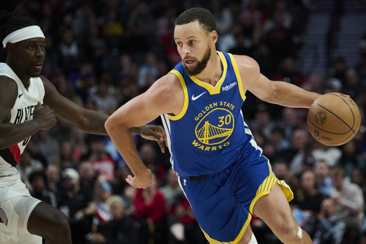 Golden State Warriors guard Stephen Curry (30) drives past Portland Trail Blazers guard Jrue Holiday (5) during the first half at Moda Center.