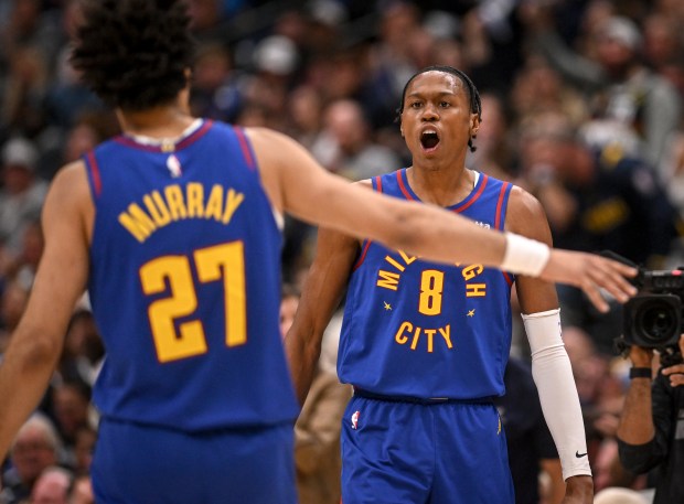Peyton Watson (8) of the Denver Nuggets erupts after running over Ben Simmons (25) of the LA Clippers for a bucket as Jamal Murray (27) greets him during the second quarter at Ball Arena in Denver on Saturday, April 19, 2025. (Photo by AAron Ontiveroz/The Denver Post)