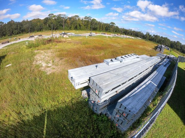 Stacked steel beams sit along Torino Road at Monza Court,...