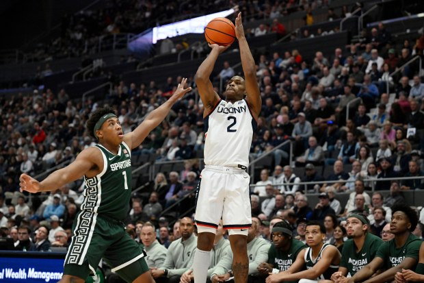 UConn guard Silas Demary Jr. (2) shoots over Michigan State guard Jeremy Fears Jr. (1) during the first half of an NCAA basketball game, Tuesday, Oct. 28, 2025, at PeoplesBank Arena in Hartford, Conn. (AP Photo/Jessica Hill)
