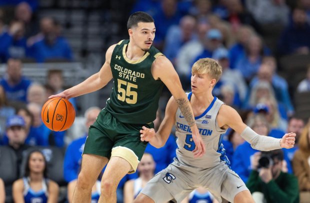 Colorado State's Jevin Muniz (55) controls the ball against Creighton's Nik Graves (5) during the first half of an NCAA college basketball exhibition game Saturday, Oct. 25, 2025, in Omaha, Neb. (AP Photo/Rebecca S. Gratz)