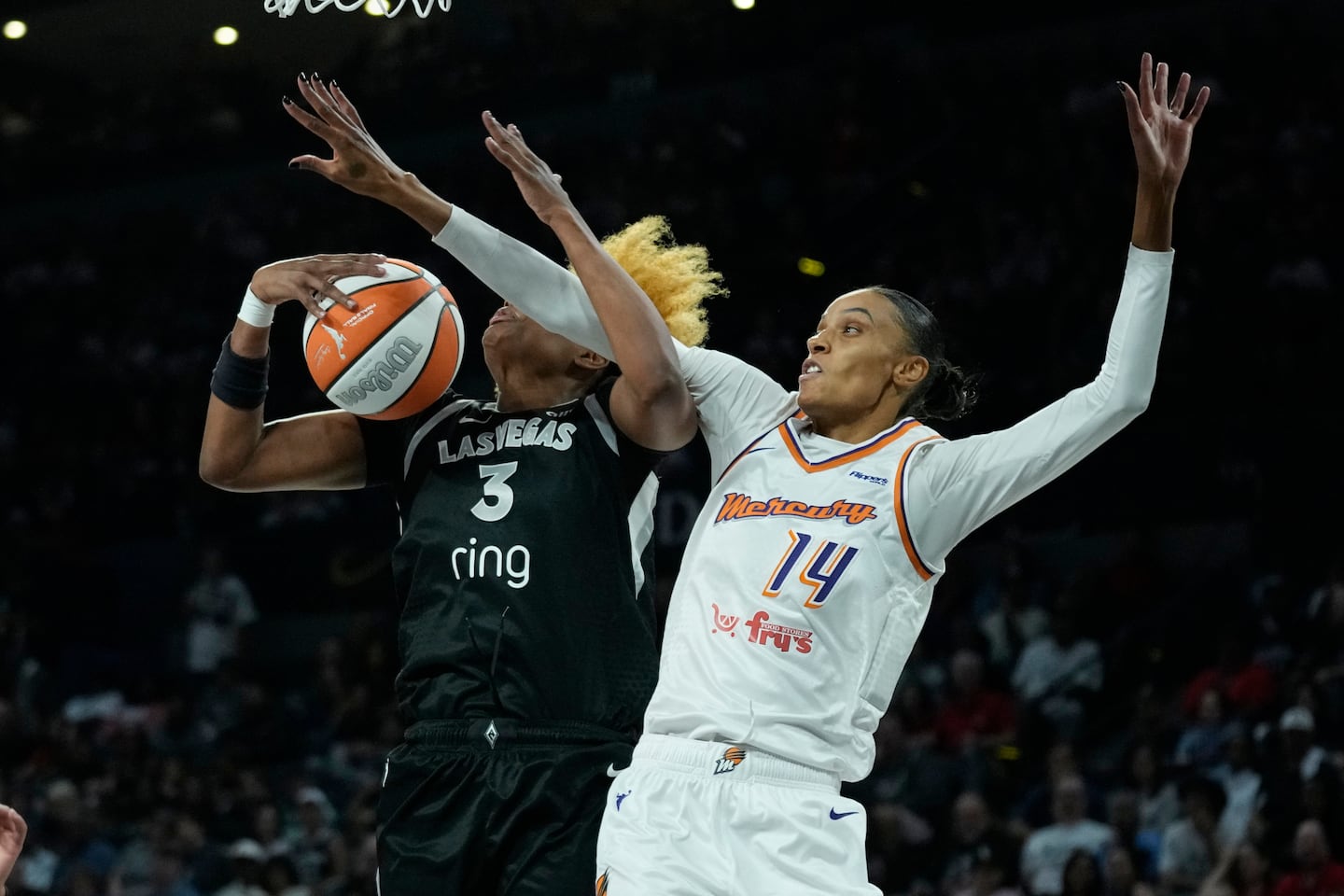 Phoenix Mercury forward DeWanna Bonner (14) gets physical with Las Vegas Aces forward NaLyssa Smith (3) during Friday's Game 1 of the WNBA Finals in Las Vegas. 
