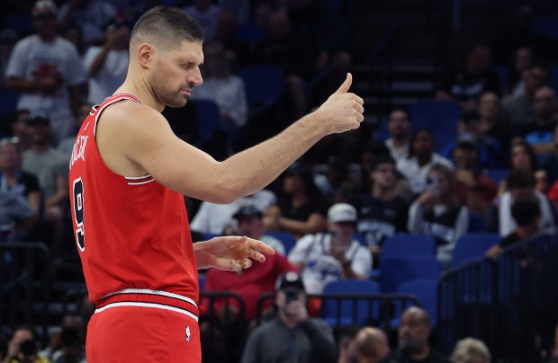 Chicago center Nikola Vucevic gives a wink and a thumbs...