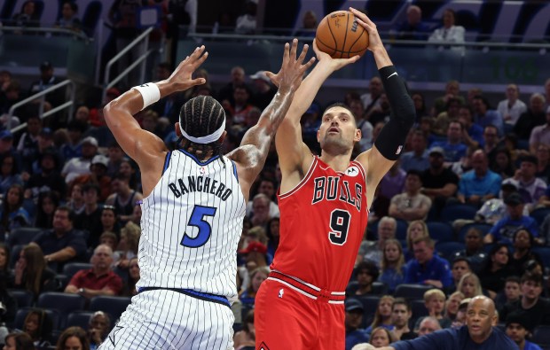 Chicago center Nikola Vucevic (9) shoots as Orlando forward Paolo...