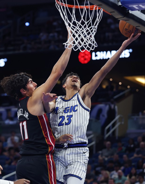 Orlando forward Tristan da Silva (23) scores beside Miami guard...