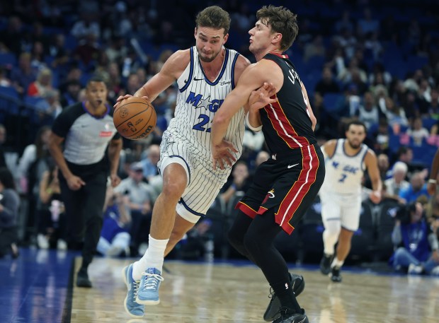 Orlando forward Franz Wagner (22) pushes aside Miami guard Pelle...