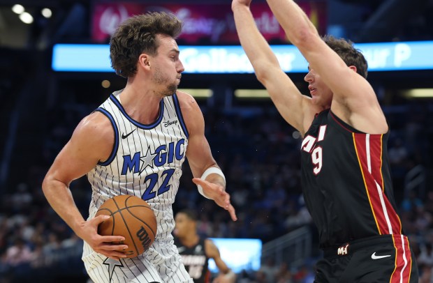 Orlando forward Franz Wagner (22) tries to drive past Miami...
