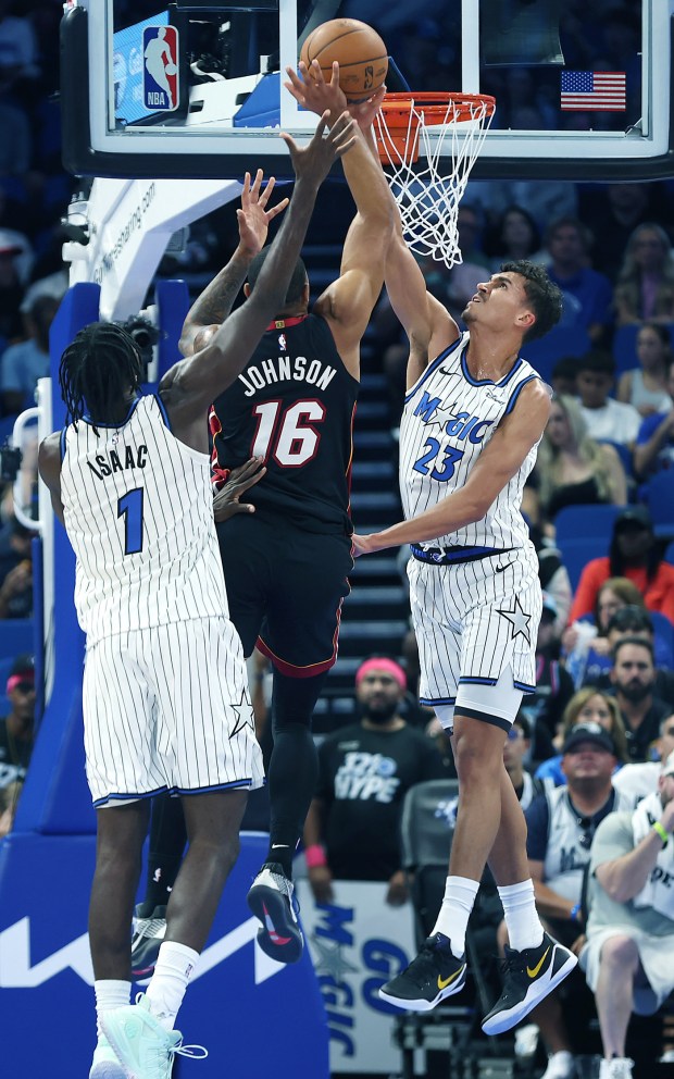Orlando forwards Jonathan Isaac (1) and Tristan da Silva (23)...