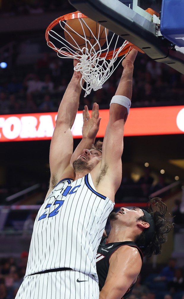 Orlando forward Franz Wagner (22) slam dunks over Miami guard...