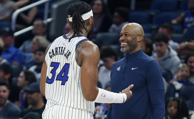 Orlando coach Jamahl Mosley talks to center Wendell Carter Jr....