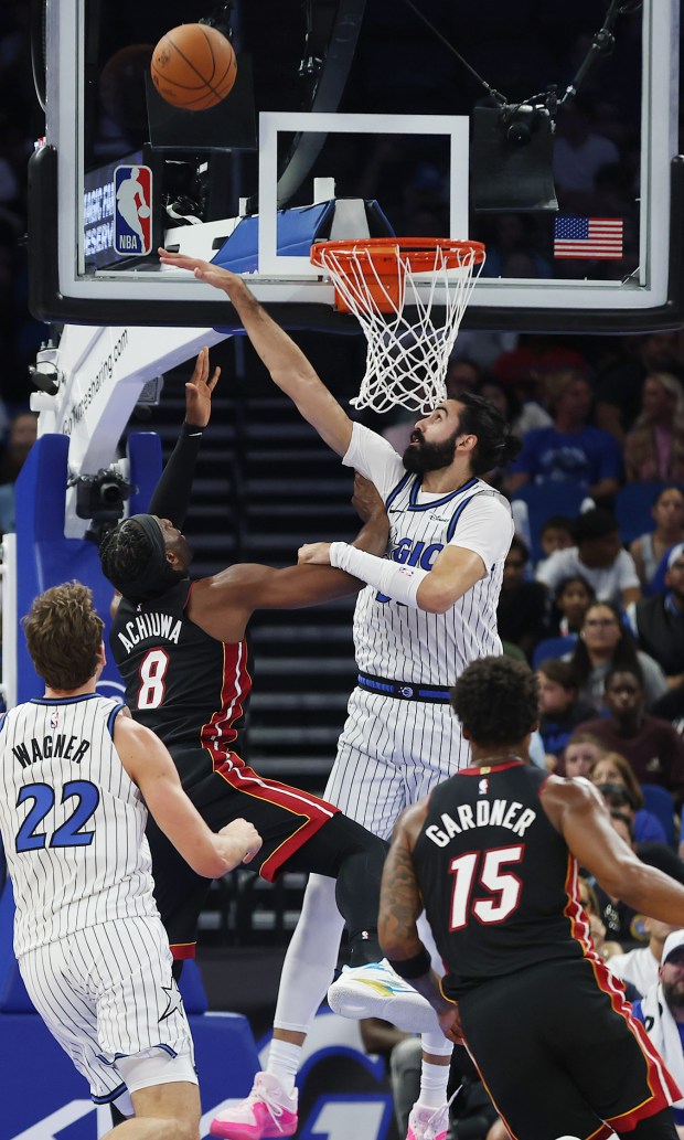 Orlando center Goga Bitadze (middle) knocks away a shot by...