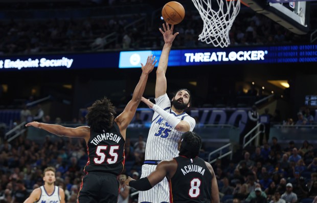 Orlando center Goga Bitadze (35) shoots over Miami guard Ethan...