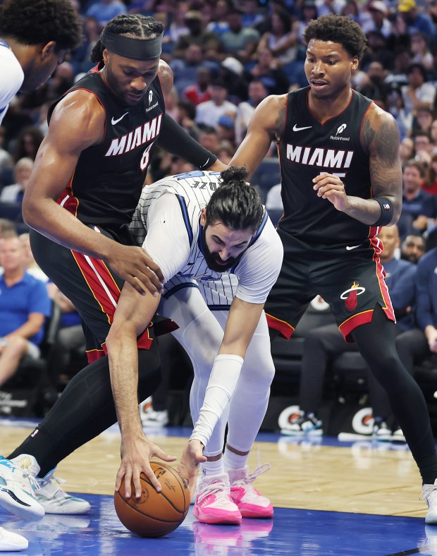 Orlando center Goga Bitadze (bottom) fights for a loose ball...