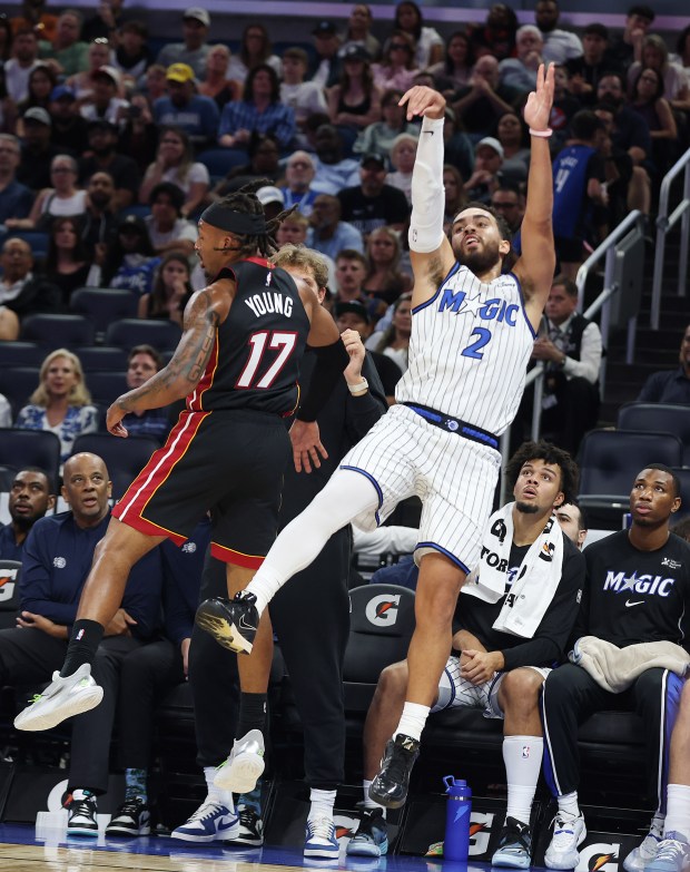 Orlando guard Tyus Jones (2) shoots a three-point shot beside...