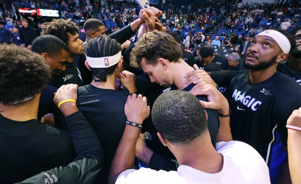 Orlando players huddle before the start of the Miami Heat...