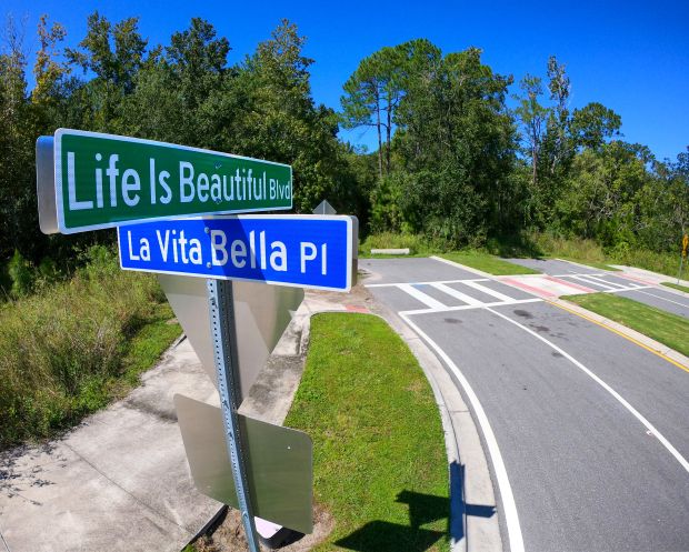 A street sign on “Life Is Beautiful Blvd.” points to...