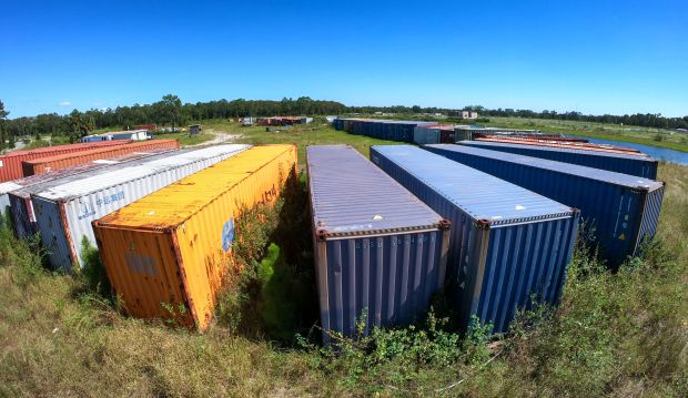Rusting shipping containers sit at the Magic Village construction site...