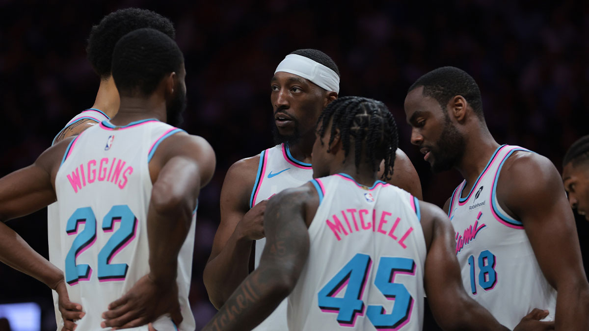Miami Heat center Bam Adebayo (13) talks to center Kel'el Ware (7), forward Andrew Wiggins (22), guard Davion Mitchell (45), and guard Alec Burks (18) during the second quarter against the Golden State Warriors at Kaseya Center.