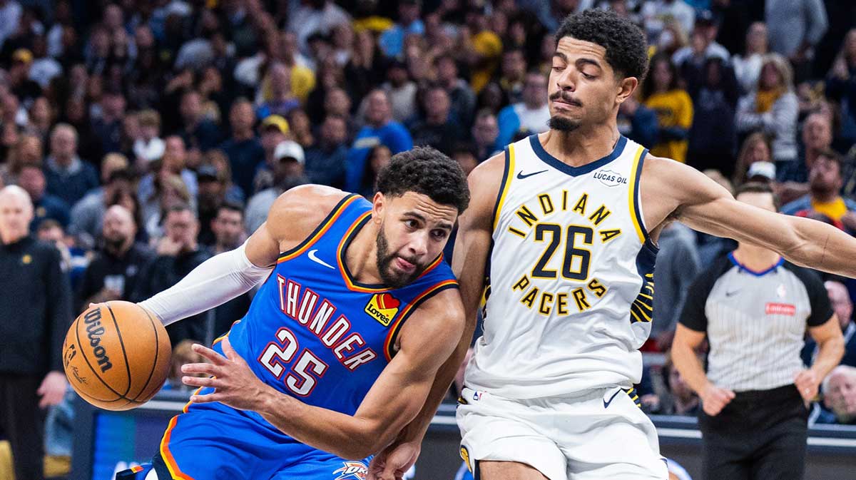 Thunder guard Ajay Mitchell (25) dribbles the ball while Indiana Pacers guard Ben Sheppard (26) defends in the second half at Gainbridge Fieldhouse