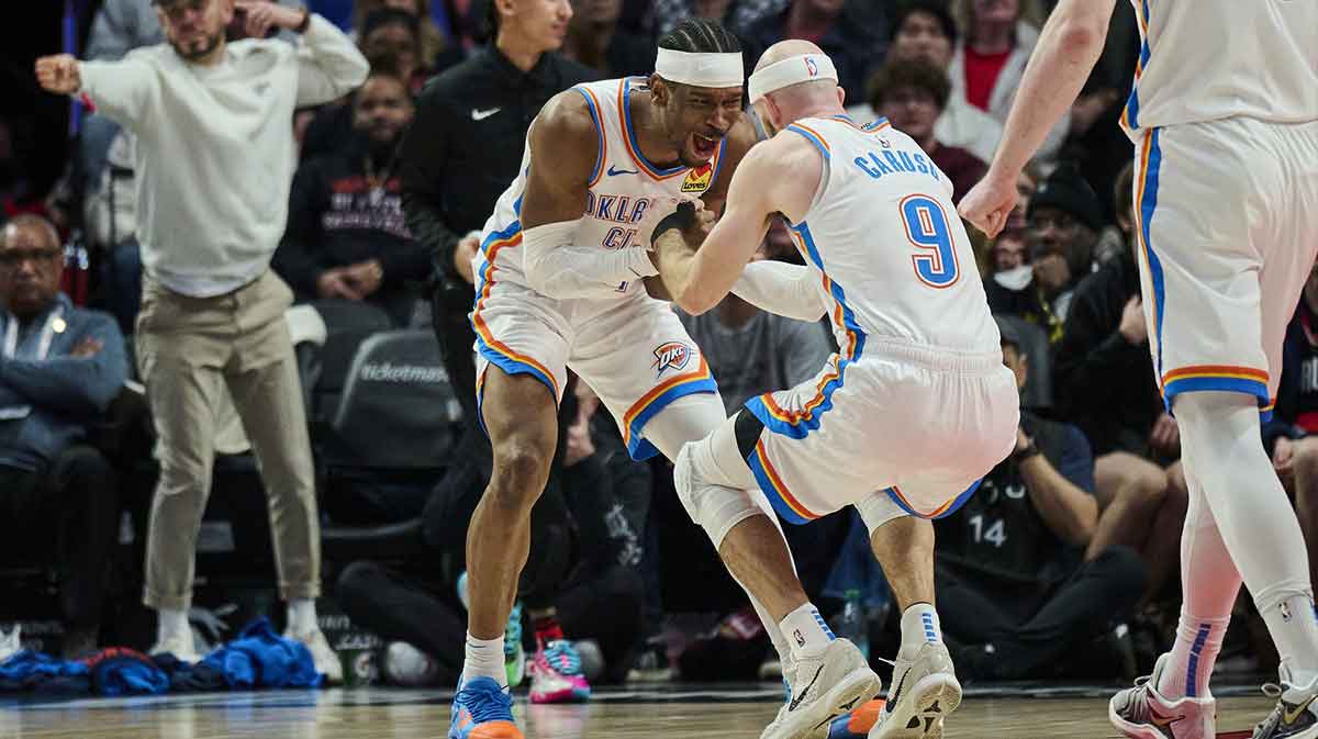 Thunder guard Shai Gilgeous-Alexander (2) celebrates with guard Alex Caruso (9) during the second half against the Portland Trail Blazers at Moda Center