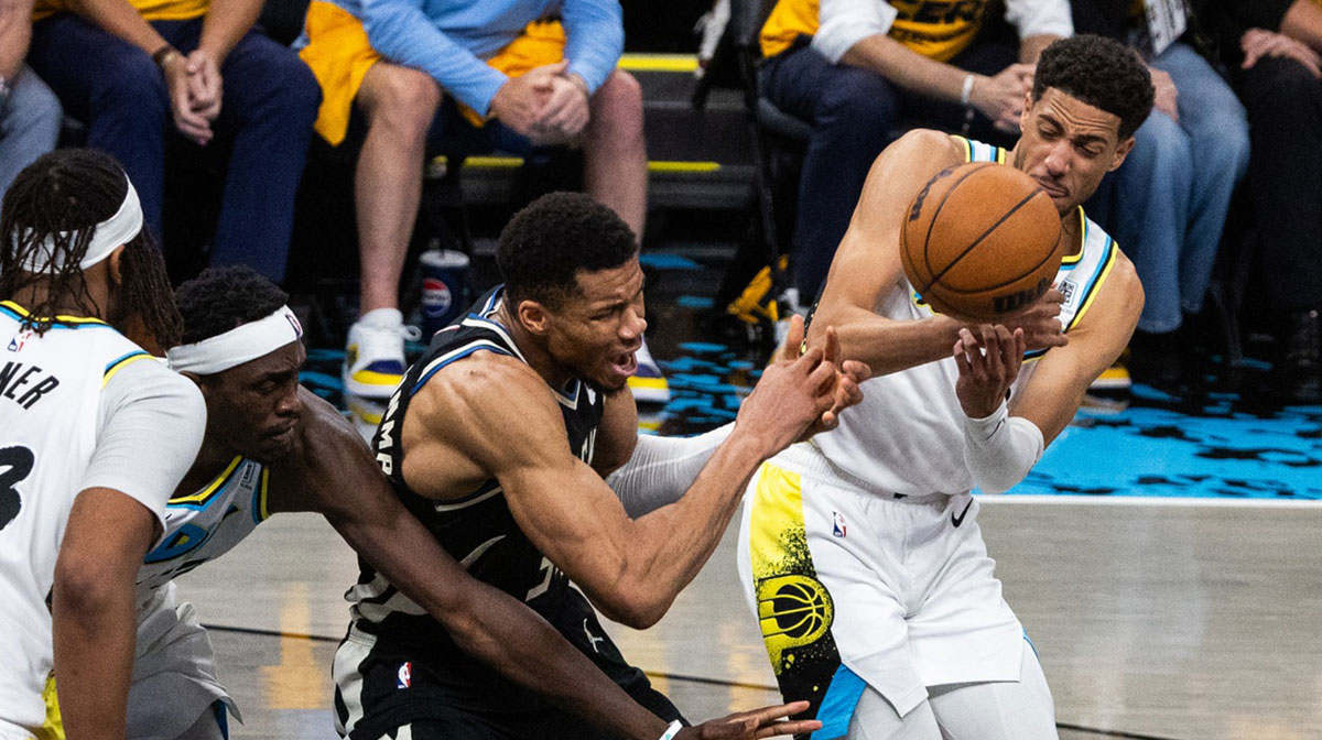 Indiana Pacers guard Tyrese Haliburton (0) steals the ball from Milwaukee Bucks forward Giannis Antetokounmpo (34) during game five of the first round for the 2024 NBA Playoffs at Gainbridge Fieldhouse.