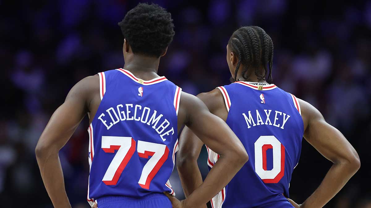 Philadelphia 76ers guard VJ Edgecombe (77) and guard Tyrese Maxey (0) look on during the third quarter against the Charlotte Hornets at Xfinity Mobile Arena. 