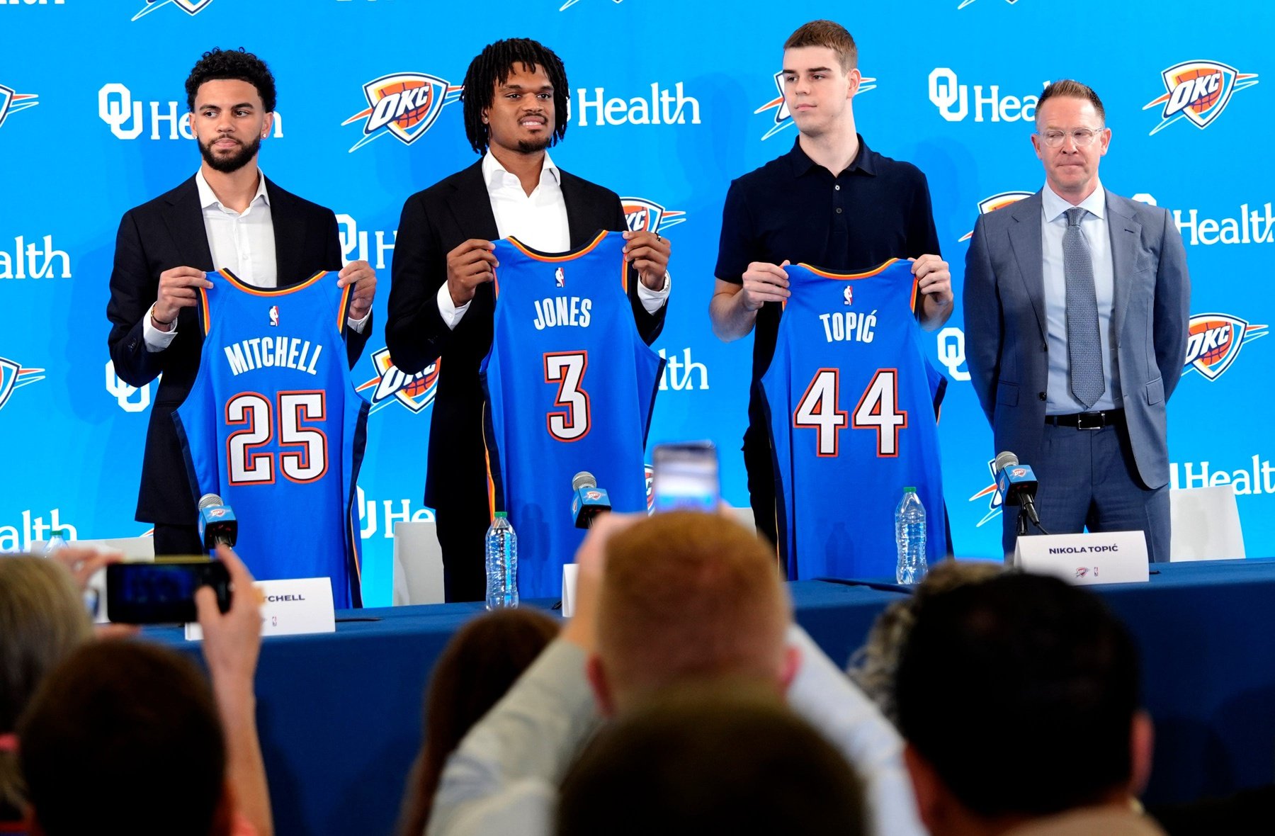 From left, Ajay Mitchell, Dillon Jones and Nikola Topic stand with Thunder general manager Sam Presti during an introductory press conference for the 2024 Thunder draft picks at Oklahoma Contemporary Arts Center in Oklahoma City, Saturday, June, 29, 2024.