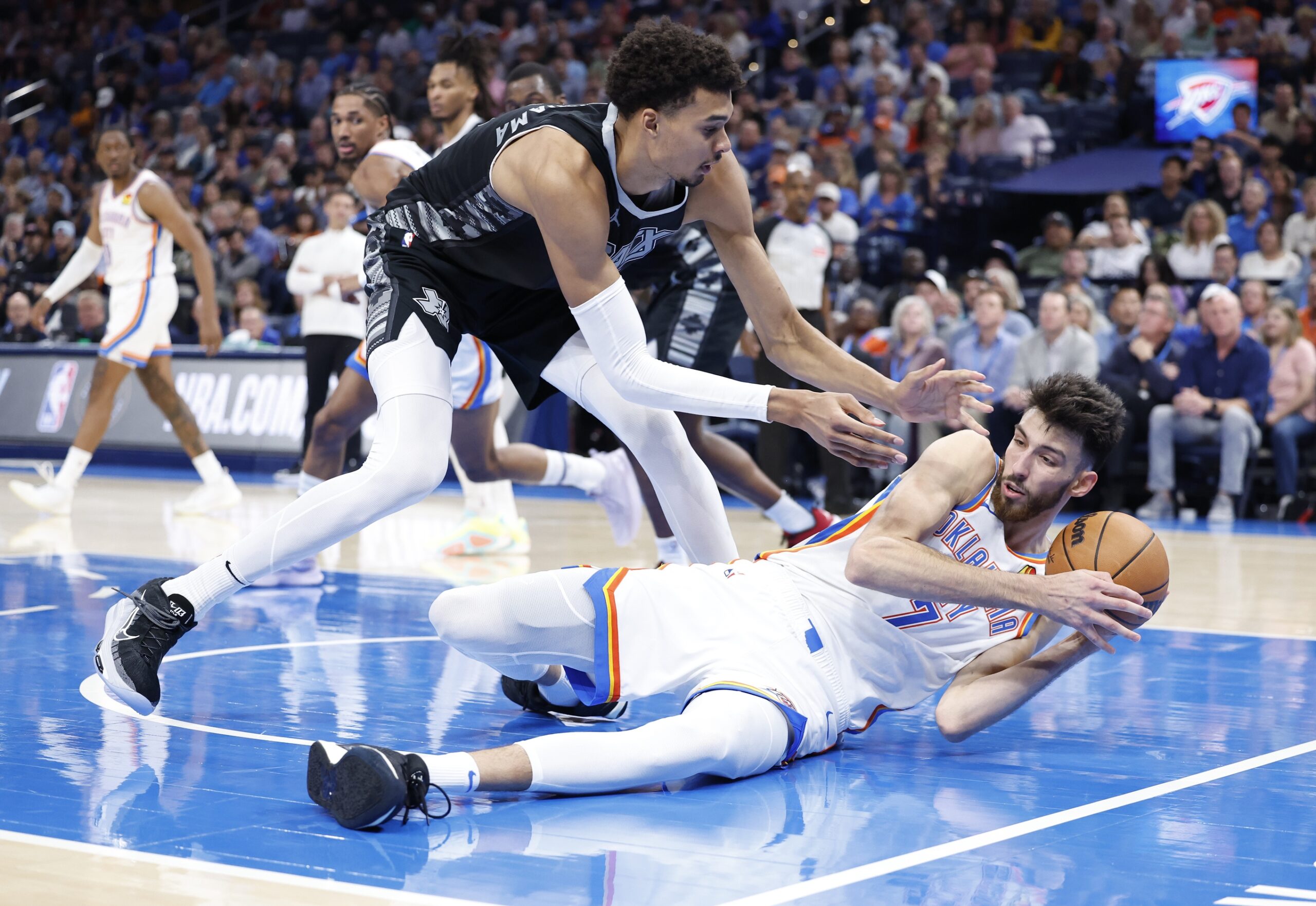 Oct 30, 2024; Oklahoma City, Oklahoma, USA; San Antonio Spurs center Victor Wembanyama (1) works to steal the ball from Oklahoma City Thunder forward Chet Holmgren (7) after he fell to the floor during the second half at Paycom Center. Mandatory Credit: Alonzo Adams-Imagn Images