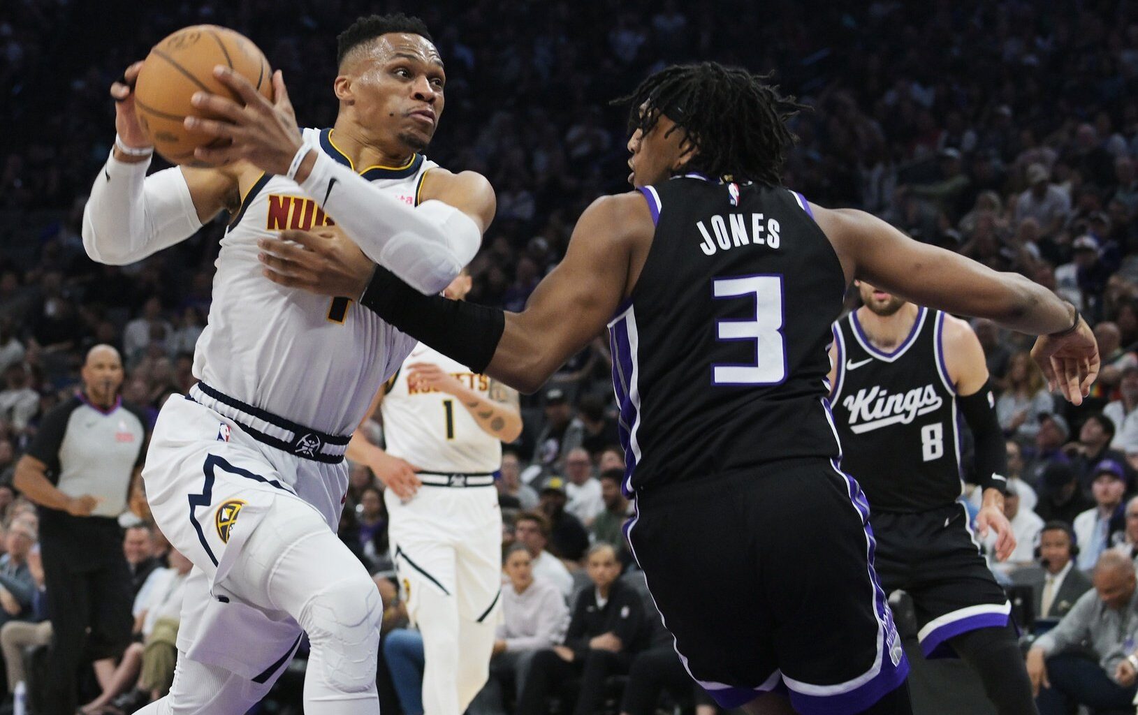 Apr 9, 2025; Sacramento, California, USA; Denver Nuggets guard Russell Westbrook (4) drives to the basket against Sacramento Kings center Isaac Jones (3) during the second quarter at Golden 1 Center. Mandatory Credit: Ed Szczepanski-Imagn Images