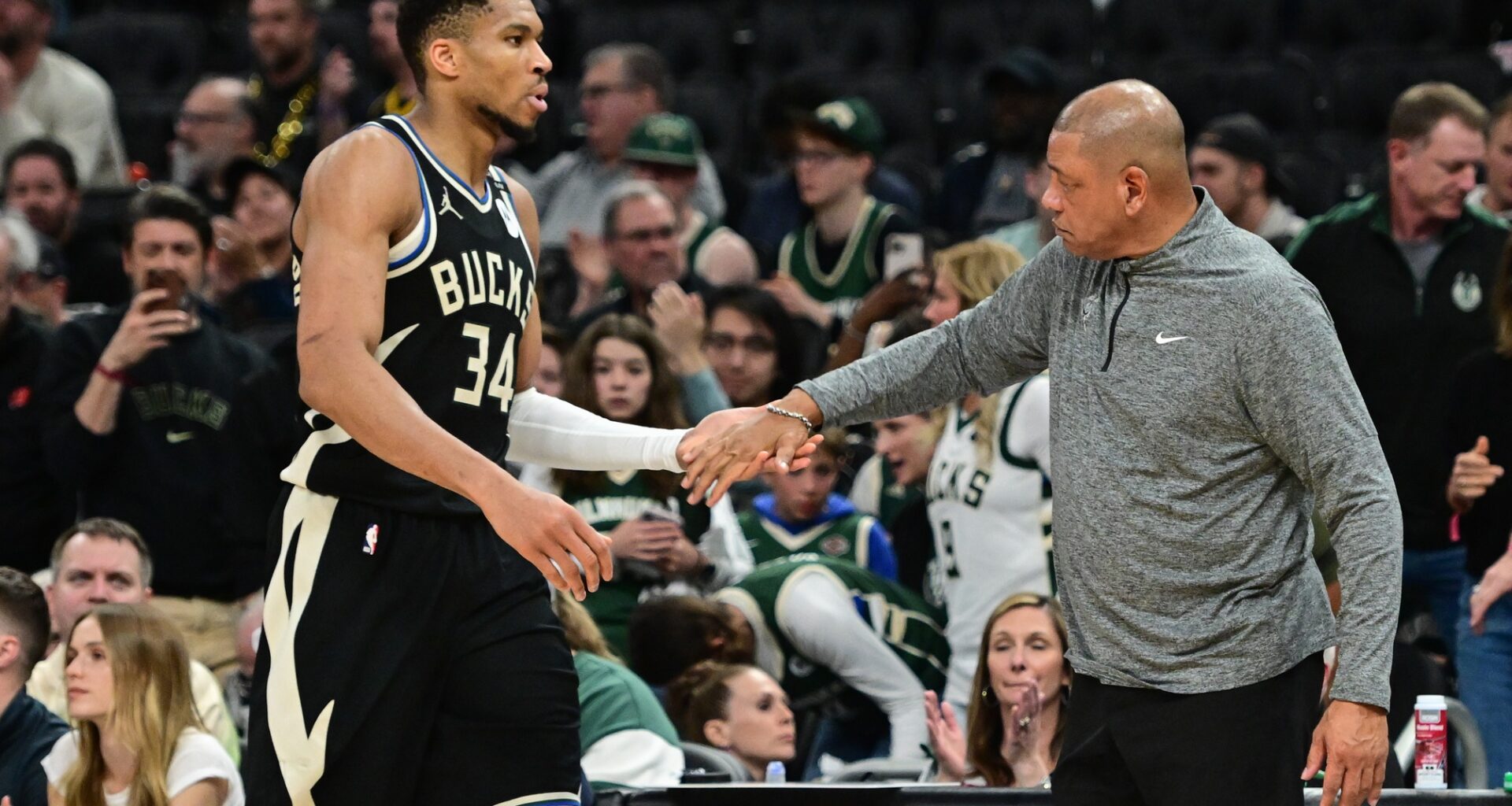 Bucks star Giannis Antetokounmpo high fives Doc Rivers during the 2024-25 NBA Playoffs.